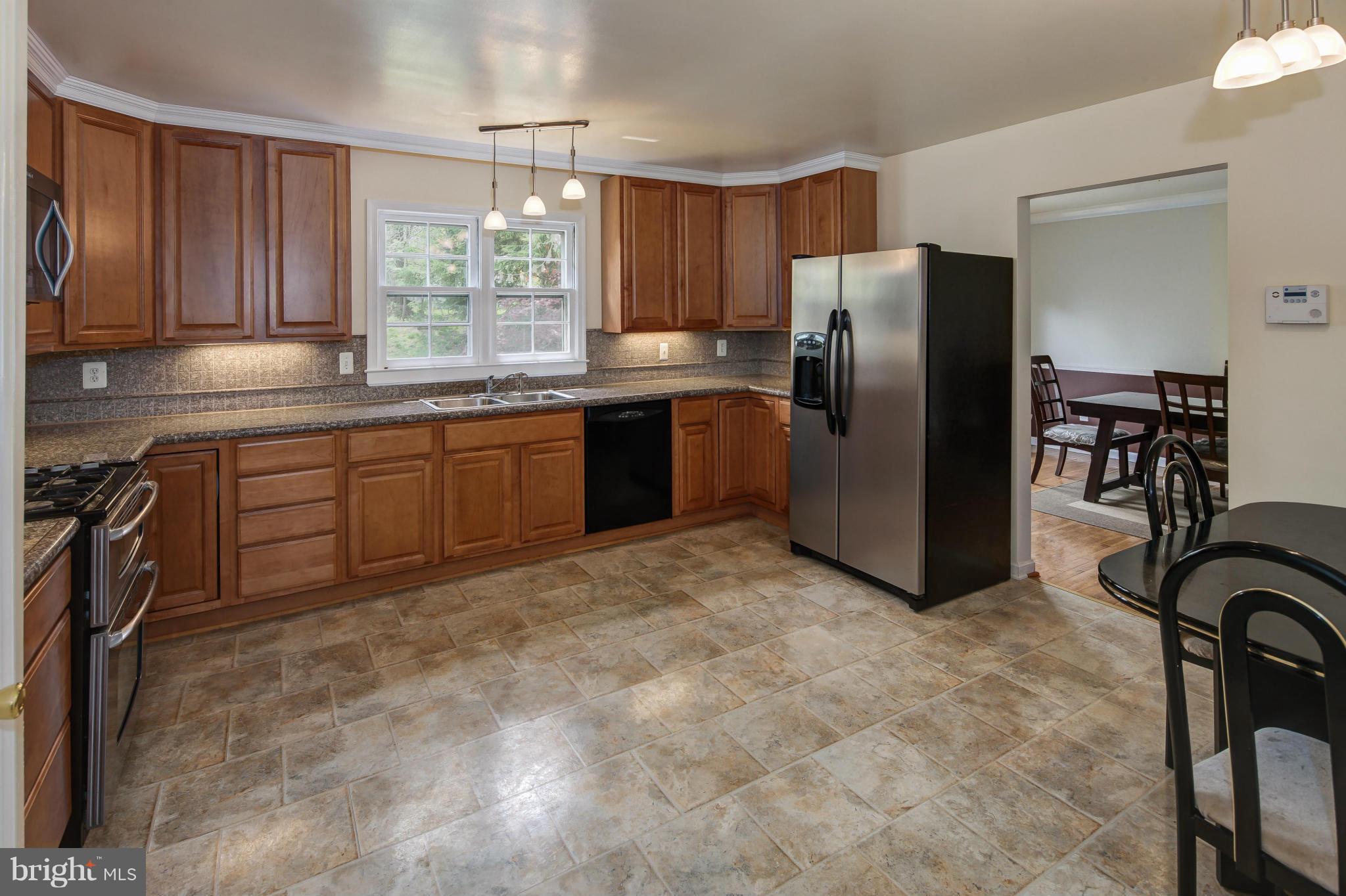 1530 Arbor View Road Silver Spring, MD 20902 - Photo 7 of 30 a kitchen with stainless steel appliances granite countertop a refrigerator and a stove top oven