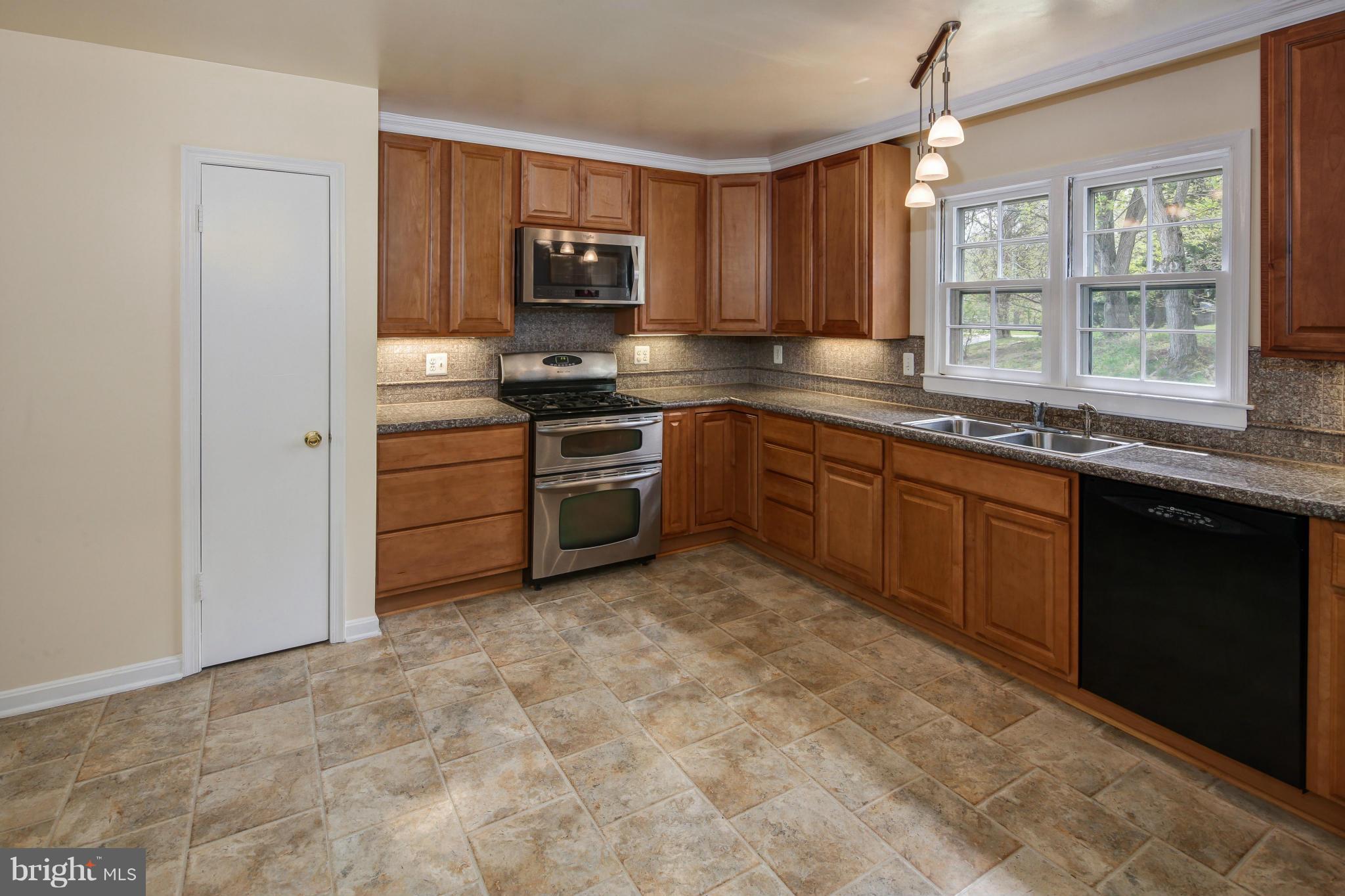 1530 Arbor View Road Silver Spring, MD 20902 - Photo 9 of 30 a kitchen with stainless steel appliances granite countertop a stove top oven a sink and dishwasher