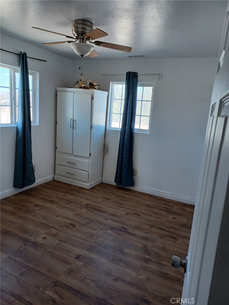 10656 Allen Way Lucerne Valley, CA 92356 - Photo 14 of 19 a view of a livingroom with a ceiling fan window and wooden floor