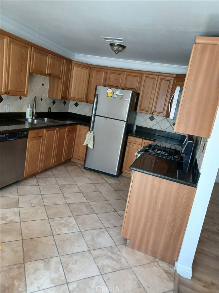 10656 Allen Way Lucerne Valley, CA 92356 - Photo 15 of 19 a kitchen with stainless steel appliances a refrigerator sink and cabinets