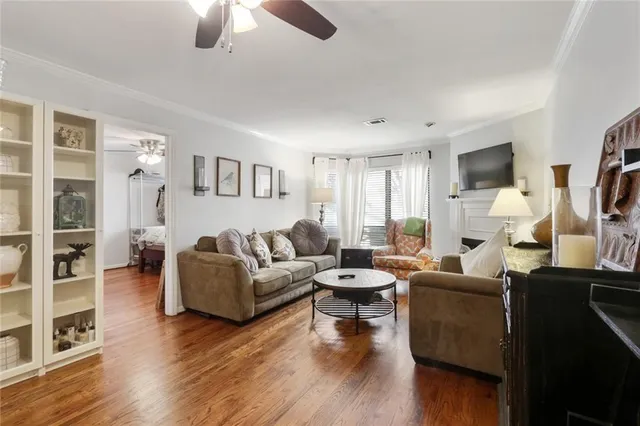 a living room with furniture flat screen tv and wooden floor