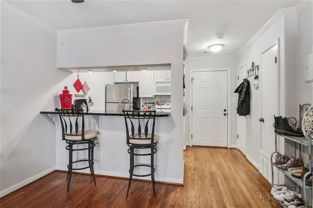 a view of a livingroom with furniture and hardwood floor