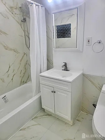 a bathroom with a sink a toilet and a bathtub