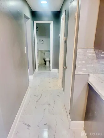 a view of a bathroom from a corridor