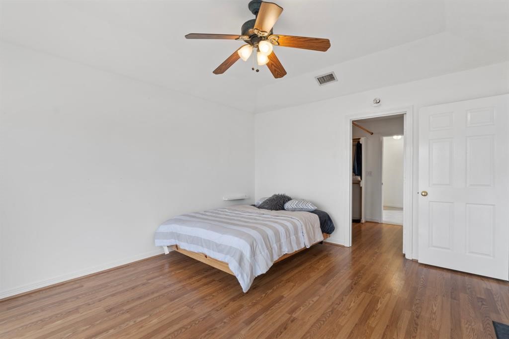 467 Pinnacle Trinity, TX 75862 - Photo 15 of 40 a bedroom with a bed ceiling fan and wooden floor