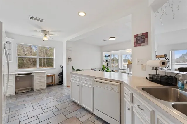 a kitchen with a sink cabinets and window