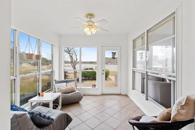 a living room with furniture and a floor to ceiling window