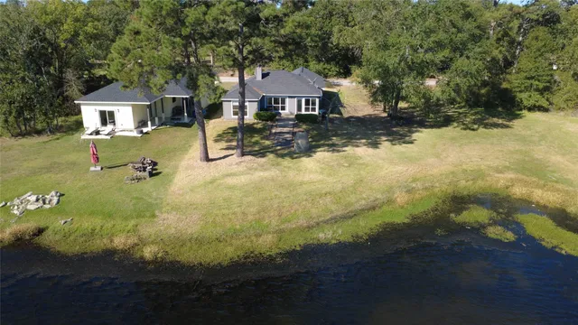 a front view of a house with yard and green space