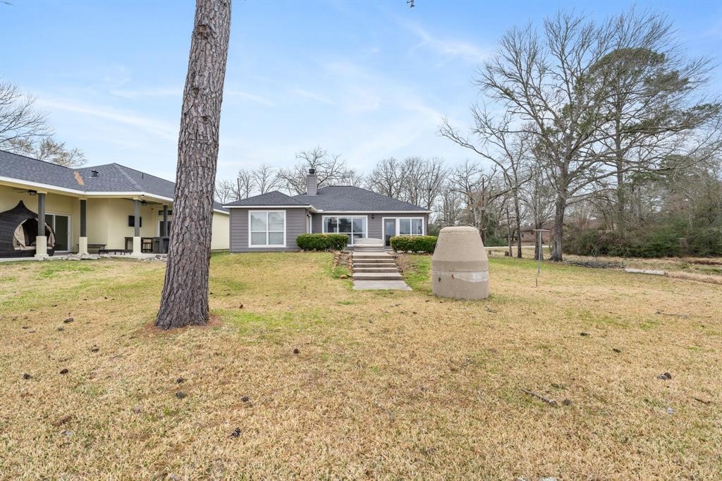 467 Pinnacle Trinity, TX 75862 - Photo 6 of 40 a white house that has a tree in front of it