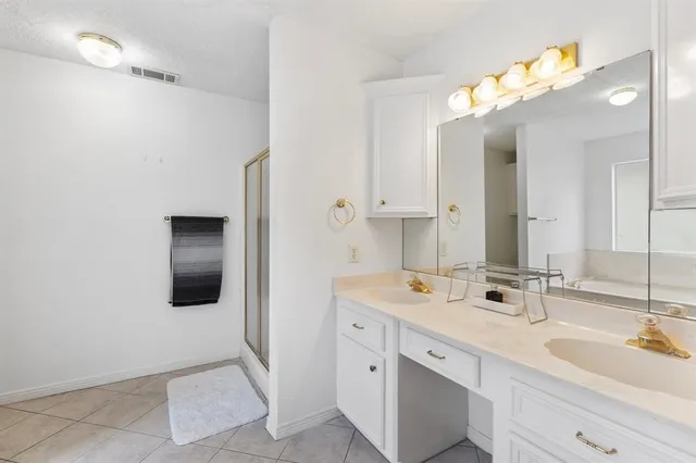a bathroom with a double vanity sink mirror and