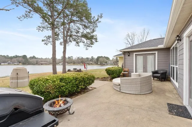 a view of a backyard with couches and swimming pool