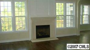 507 Quicksilver Trail, Unit 35 Fort Mill, SC 29708 - Photo 3 of 7 wooden floor in an empty room with a fireplace