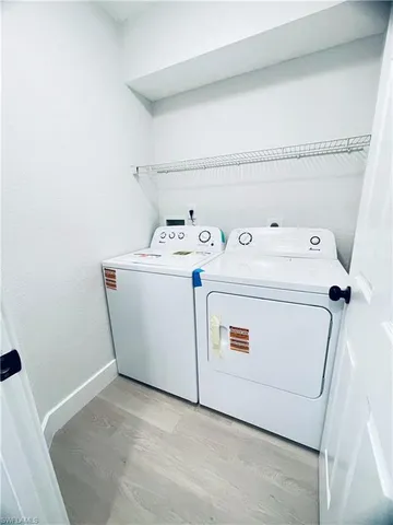 an empty room with fan and windows