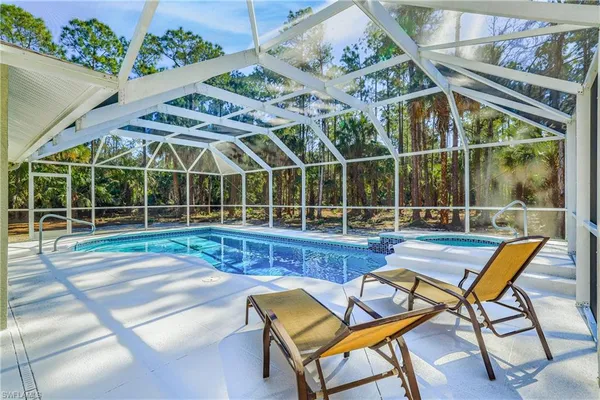 a view of a house with swimming pool and sitting area