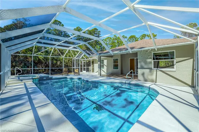 a view of a swimming pool with a lounge chair