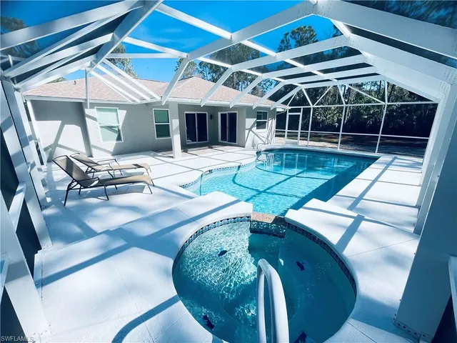 a view of a backyard with swimming pool