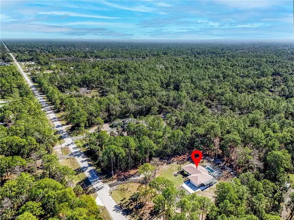 a view of a swimming pool with a yard