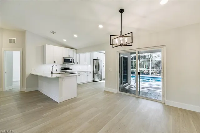 a kitchen with sink a microwave and refrigerator
