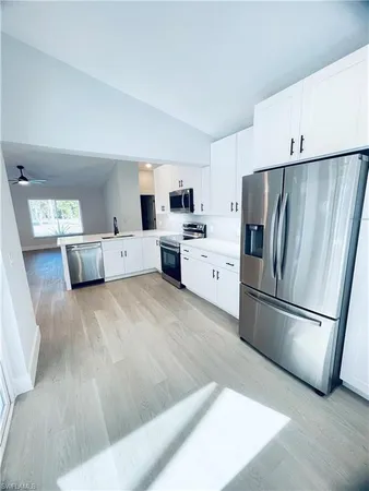a kitchen with a refrigerator a stove top oven a sink and dishwasher