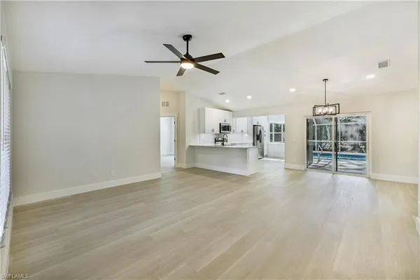 a view of kitchen with cabinets appliances and wooden floor