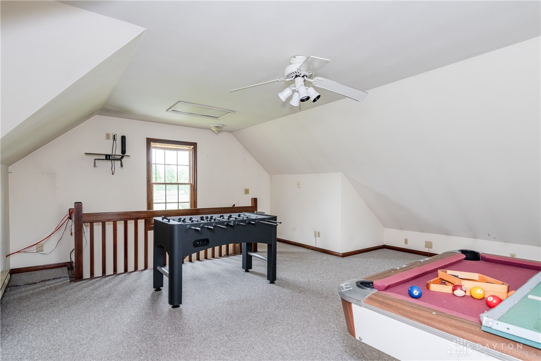 9981 Ridge Acres Lane Englewood, OH 45322 - Photo 42 of 73 This spacious bonus room features sloped ceilings and ample space for recreation and relaxation.