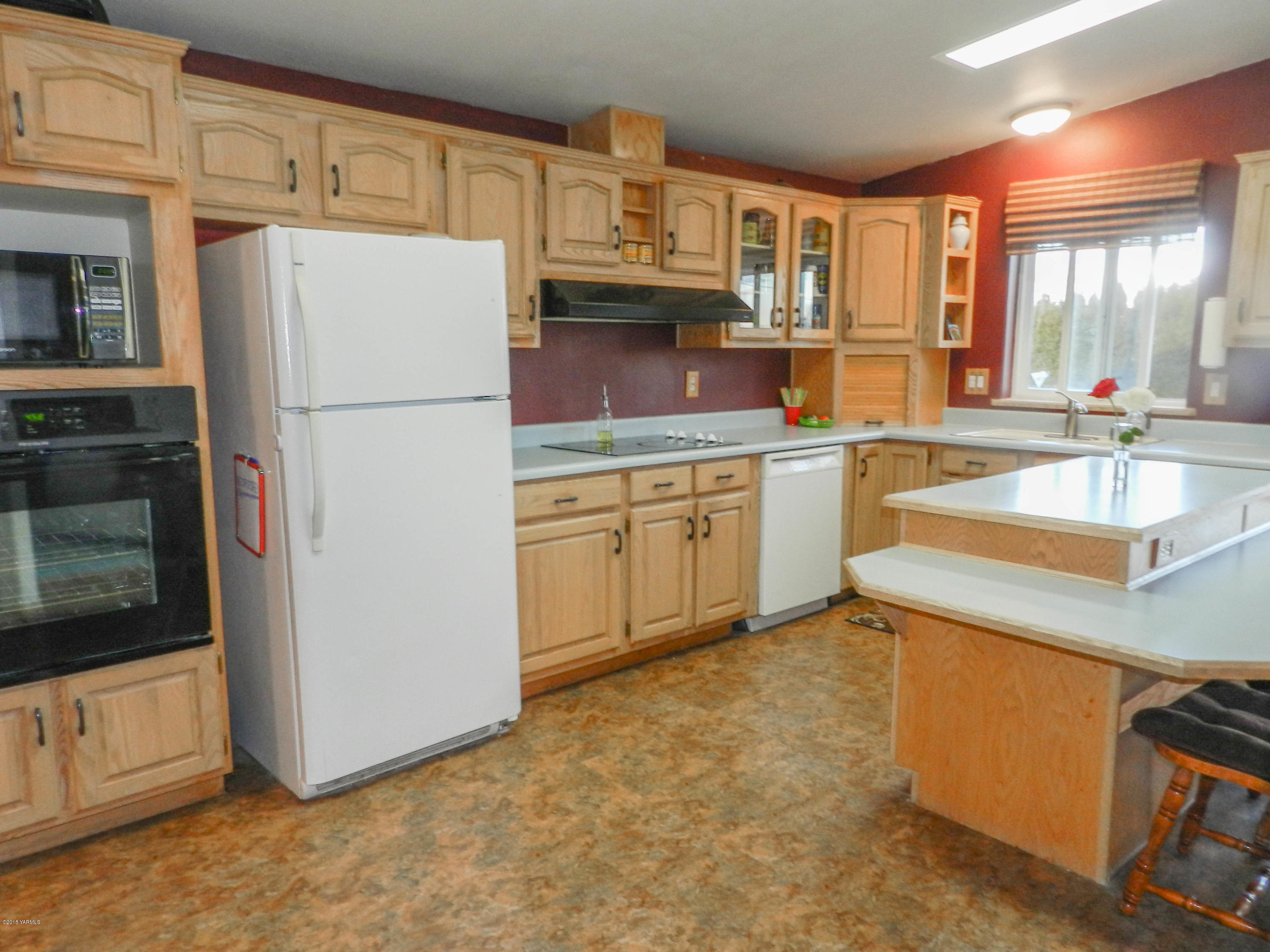 14811 Douglas Road Yakima, WA 98908 - Photo 5 of 18 a kitchen with cabinets and stainless steel appliances