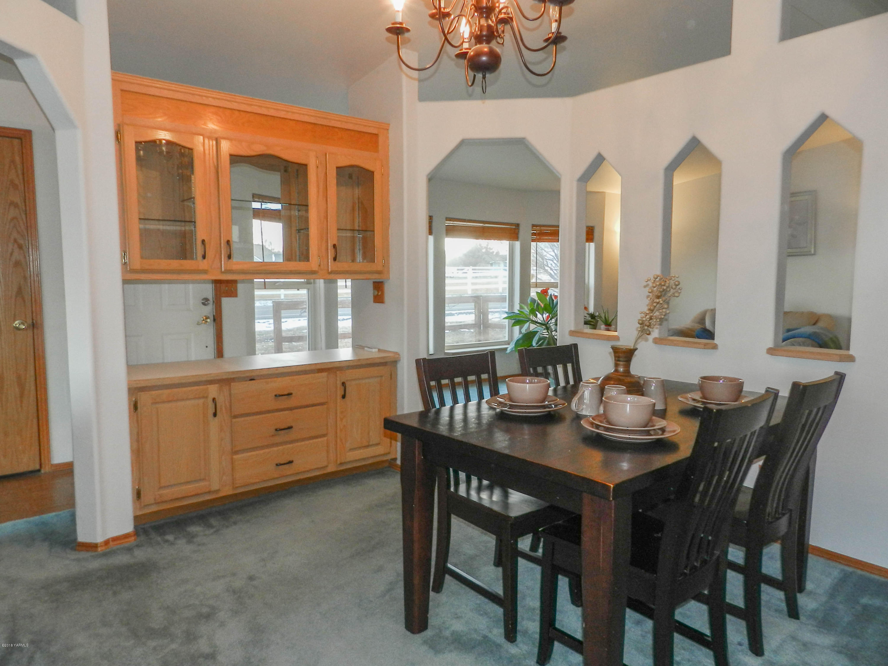 14811 Douglas Road Yakima, WA 98908 - Photo 7 of 18 a dining room with furniture a livingroom and chandelier