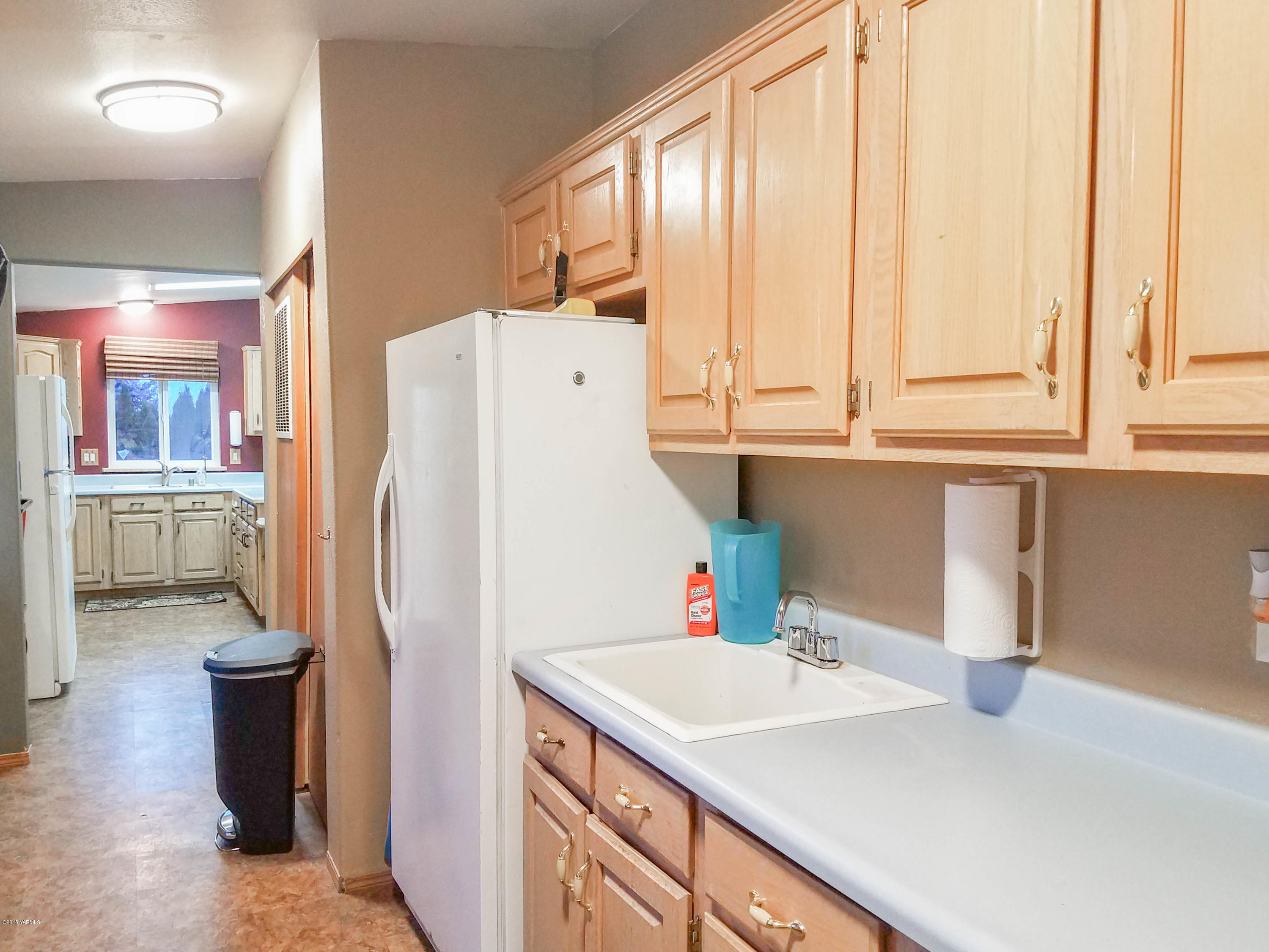 14811 Douglas Road Yakima, WA 98908 - Photo 8 of 18 a kitchen with a sink a refrigerator and a stove