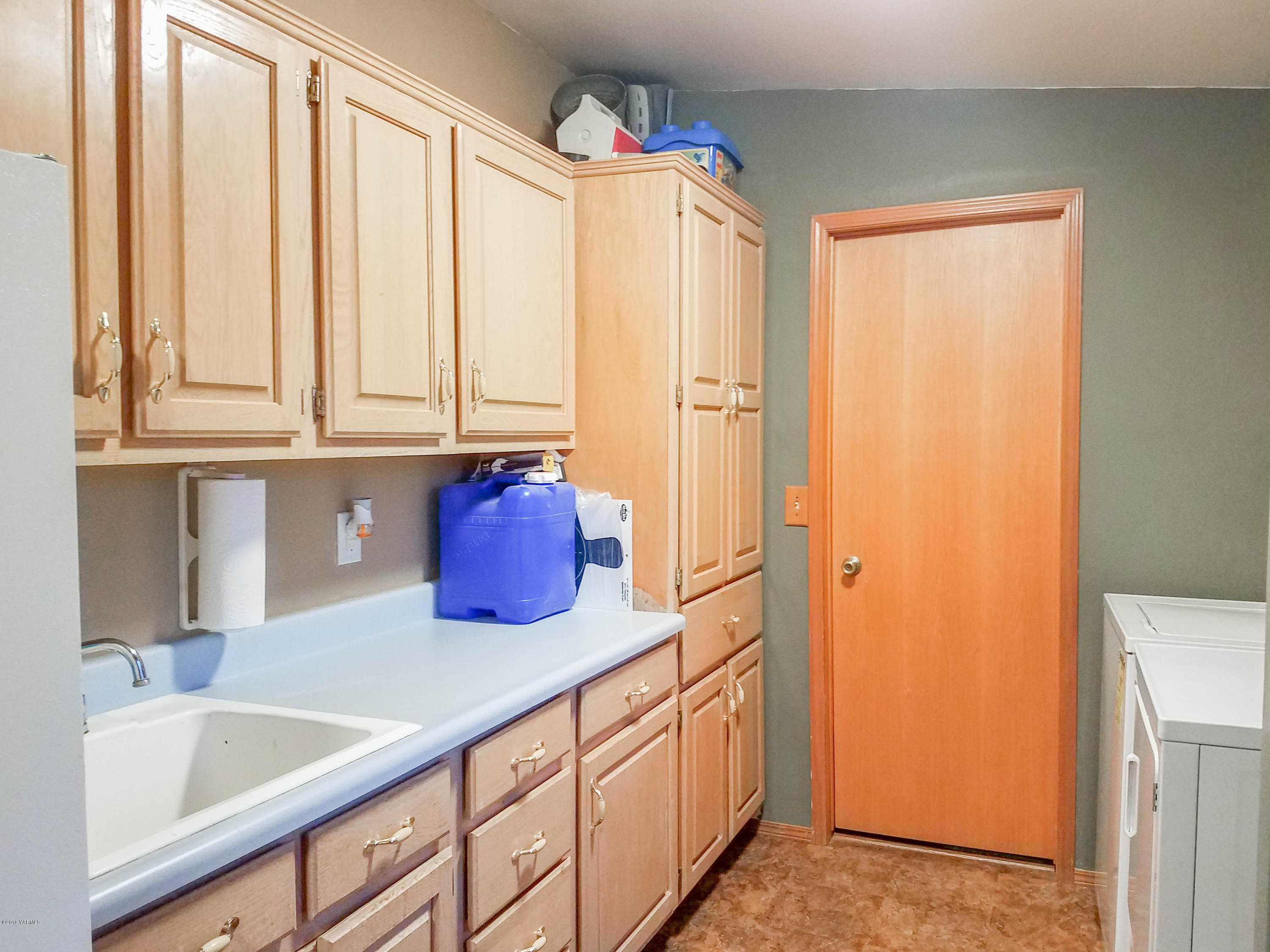 14811 Douglas Road Yakima, WA 98908 - Photo 9 of 18 a kitchen with a sink and a refrigerator