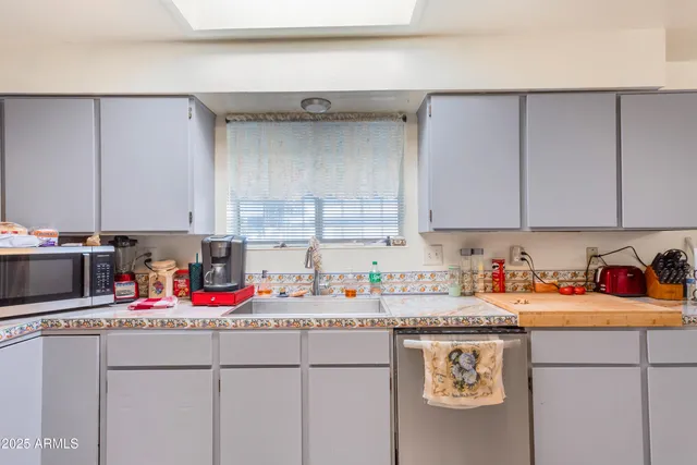 a workspace with furniture and kitchen view