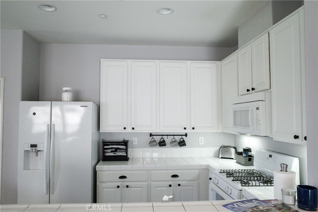7331 Shelby Place Rancho Cucamonga, CA 91739 - Photo 11 of 17 a kitchen with stainless steel appliances white cabinets and refrigerator