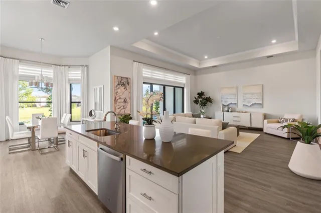 a kitchen with counter space sink stove and wooden floor