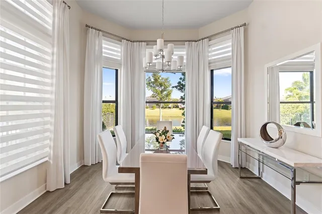a view of a dining room with furniture window and wooden floor