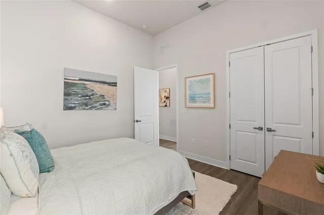 a bedroom with a bed and a desk