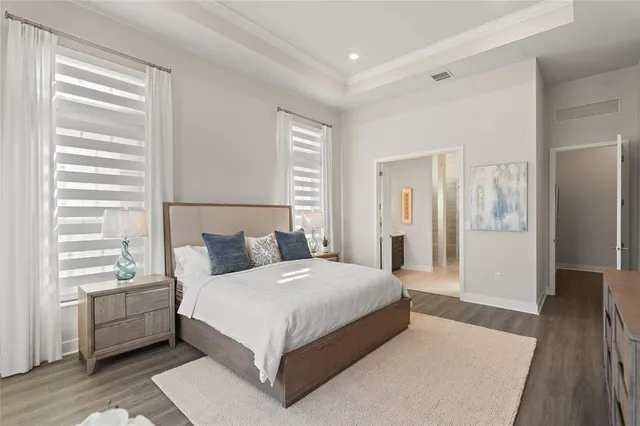 a bedroom with a large bed and a wooden floor