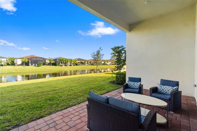 a view of a lake with couches and city view