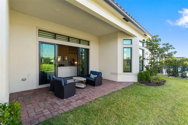 a view of a chair and table in backyard of the house