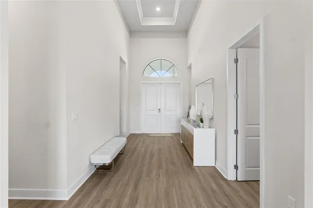 a view of a hallway with wooden floor and staircase