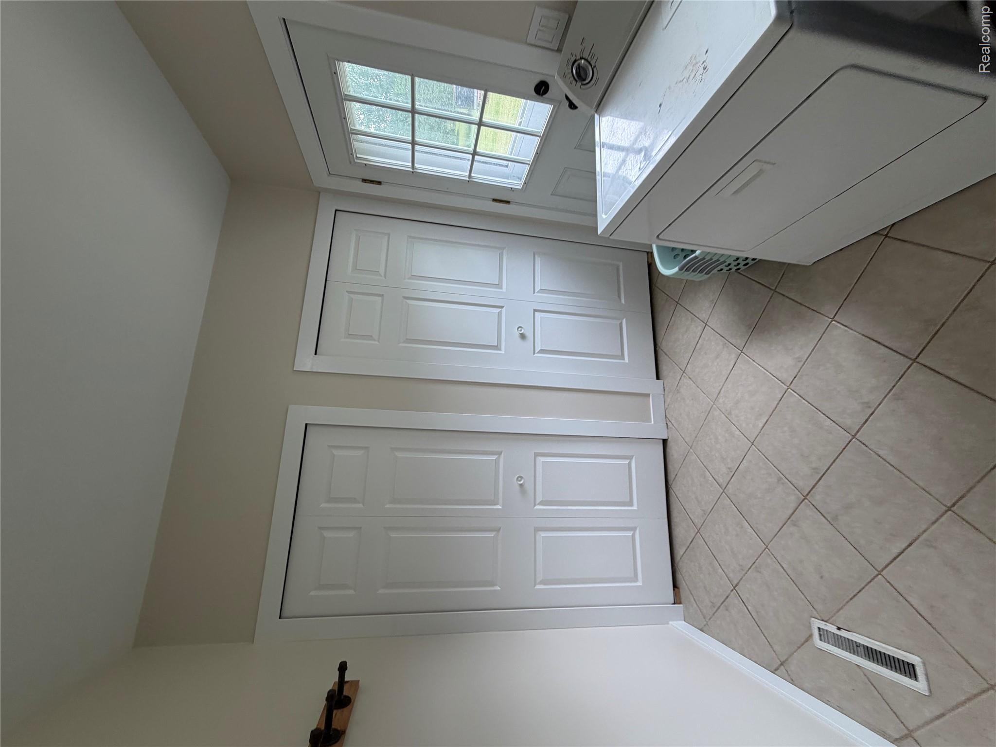 2712 North Branch Road North Branch, MI 48461 - Photo 20 of 37 Bathroom featuring washer / clothes dryer, a closet, and light tile patterned floors