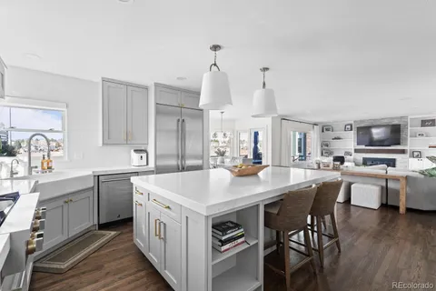 a kitchen with stainless steel appliances granite countertop a sink stove and cabinets
