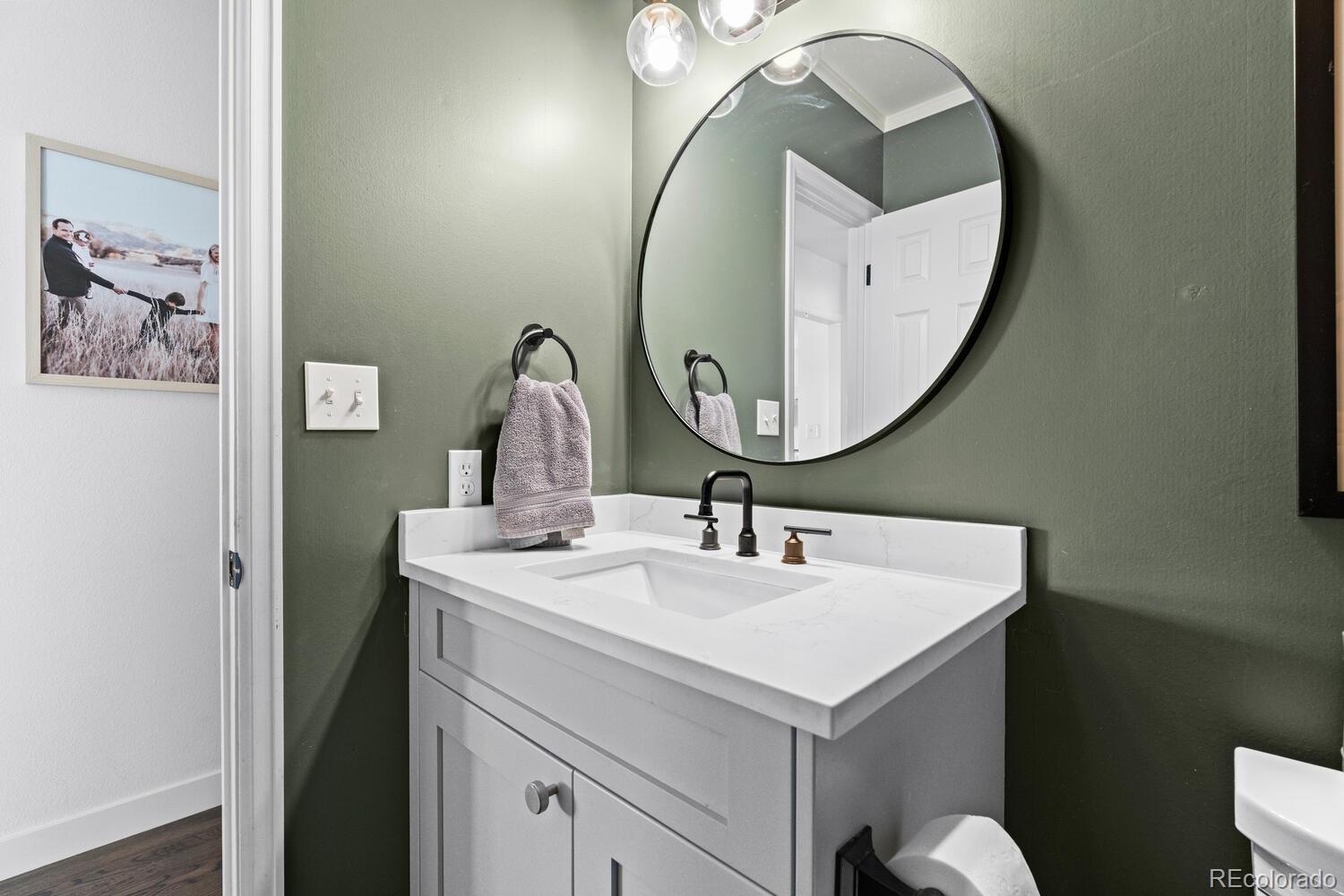 8855 South Wild Iris Run Highlands Ranch, CO 80126 - Photo 19 of 48 a bathroom with a sink and a mirror