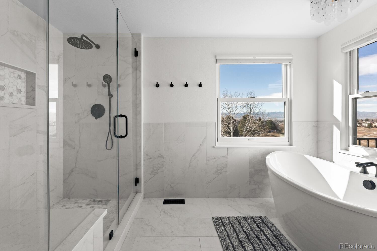 8855 South Wild Iris Run Highlands Ranch, CO 80126 - Photo 24 of 48 a bathroom with a bathtub and a shower