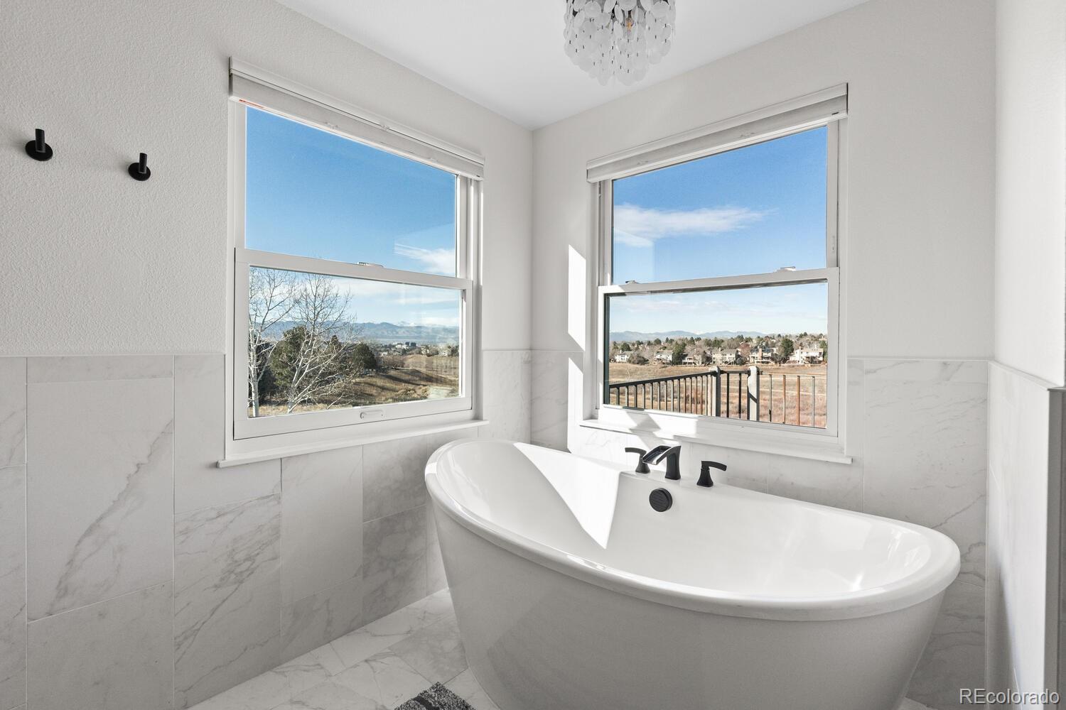 8855 South Wild Iris Run Highlands Ranch, CO 80126 - Photo 25 of 48 a white bath tub sitting next to a window