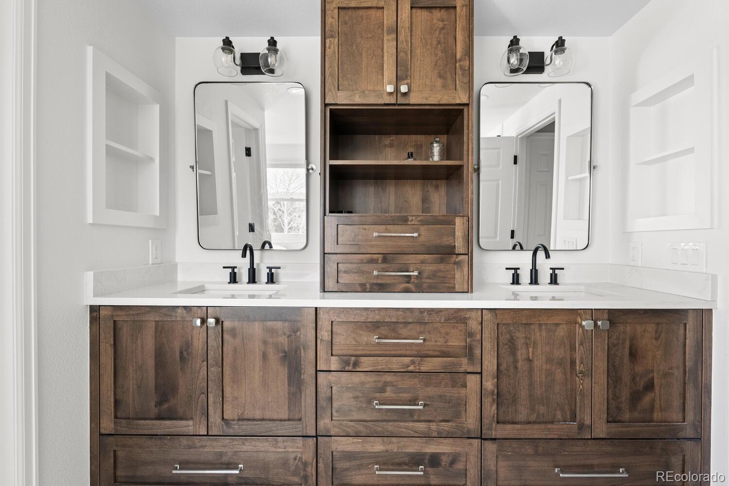 8855 South Wild Iris Run Highlands Ranch, CO 80126 - Photo 26 of 48 a bathroom with a sink and a mirror