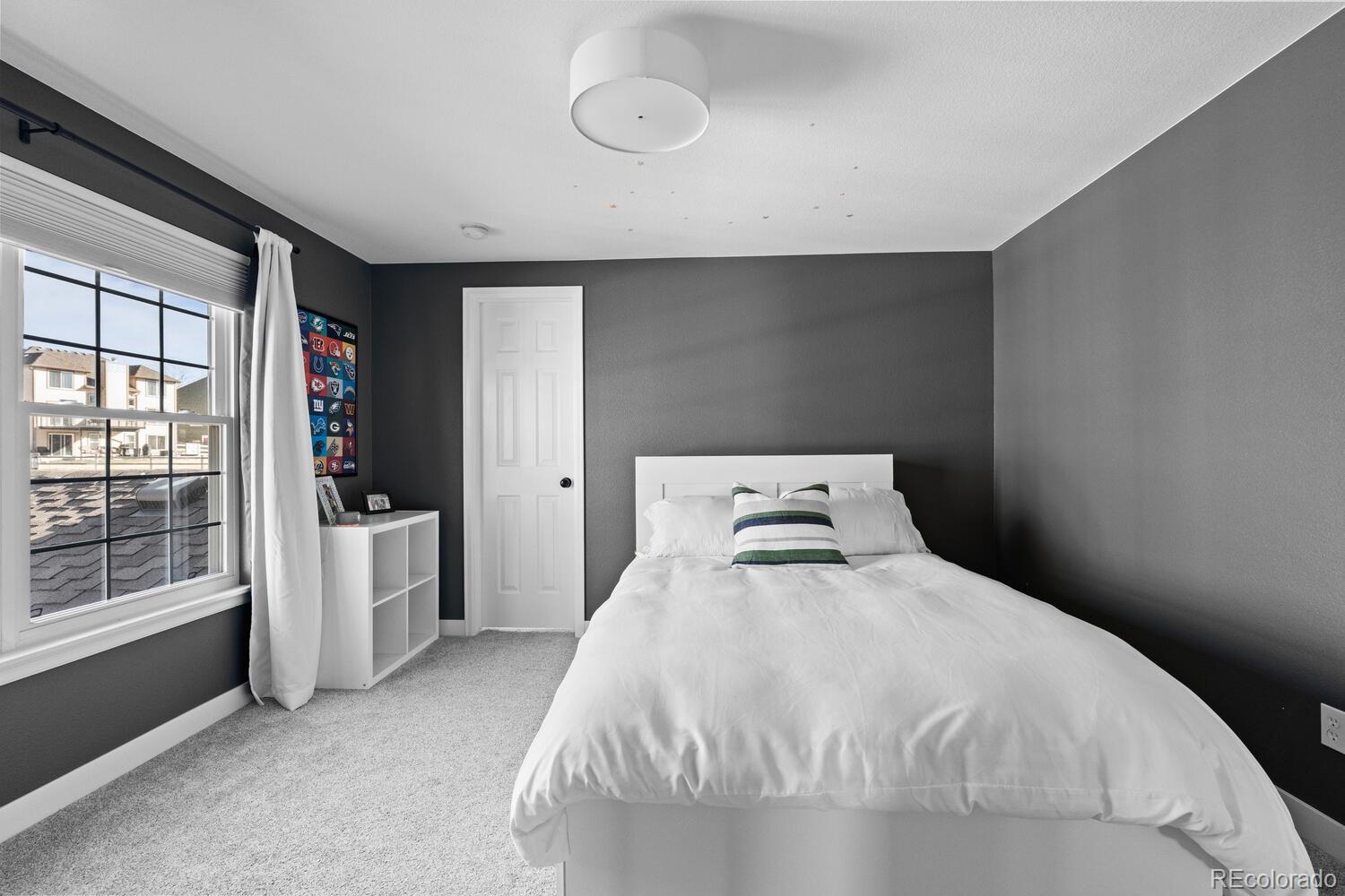 8855 South Wild Iris Run Highlands Ranch, CO 80126 - Photo 28 of 48 a bedroom with a bed and a large window