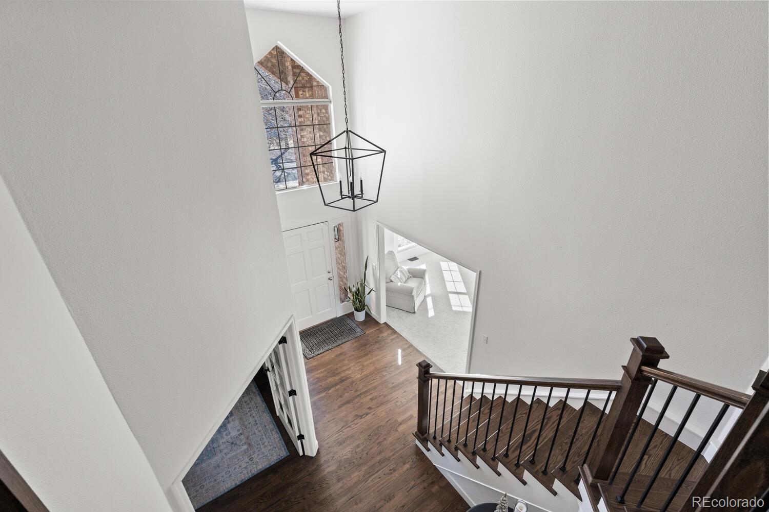 8855 South Wild Iris Run Highlands Ranch, CO 80126 - Photo 30 of 48 a view of a hallway with wooden floor
