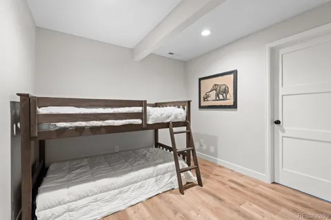 a view of a hallway with wooden floor and closet