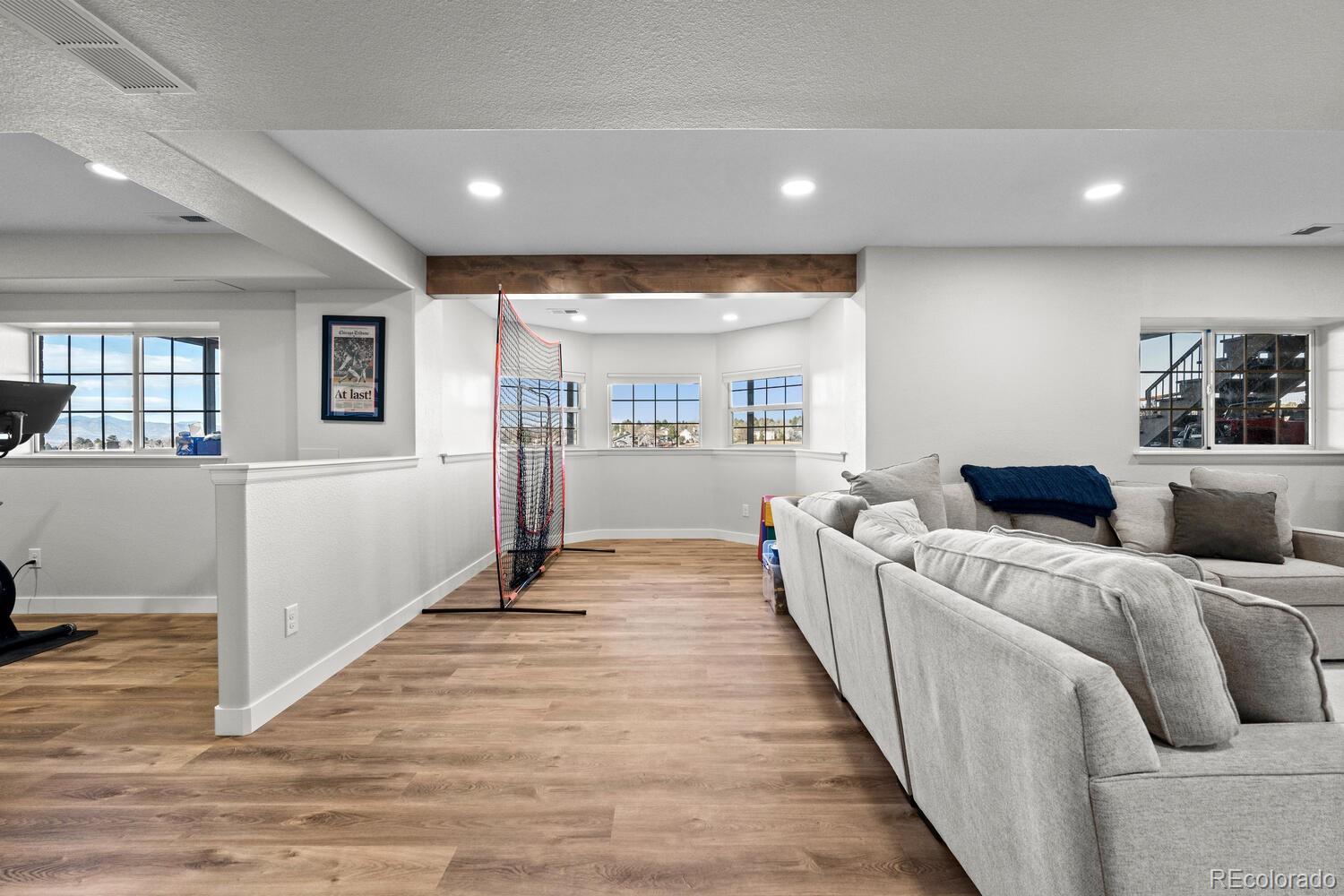 8855 South Wild Iris Run Highlands Ranch, CO 80126 - Photo 35 of 48 a room with furniture and a wooden floor