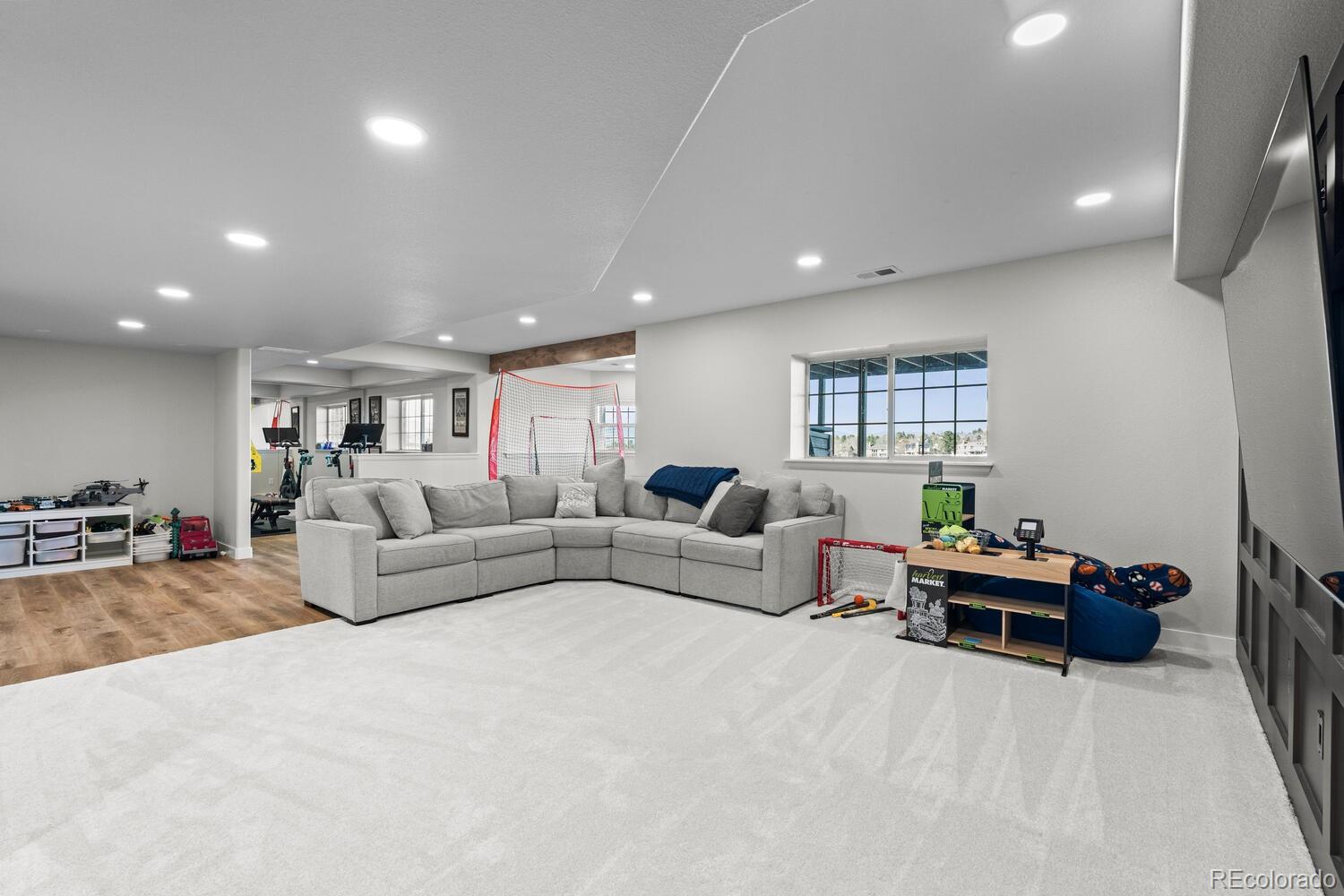 8855 South Wild Iris Run Highlands Ranch, CO 80126 - Photo 38 of 48 a living room with furniture and a wooden floor