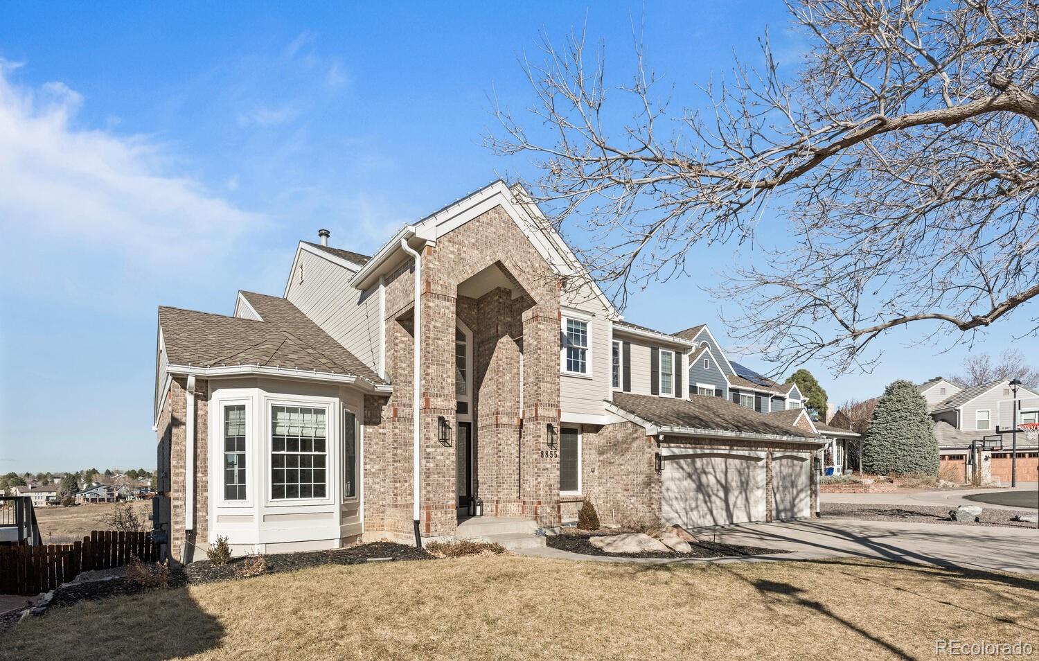 8855 South Wild Iris Run Highlands Ranch, CO 80126 - Photo 45 of 48 a front view of a house with a yard